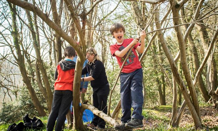 Boy balancing on branch bushcraft activity